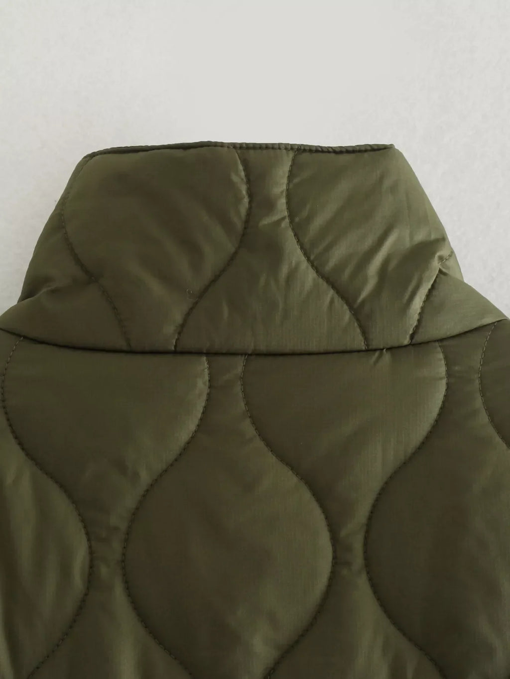 Olive quilted hood with circular stitch pattern