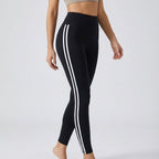 High-waisted black workout leggings with three white side stripe lines.