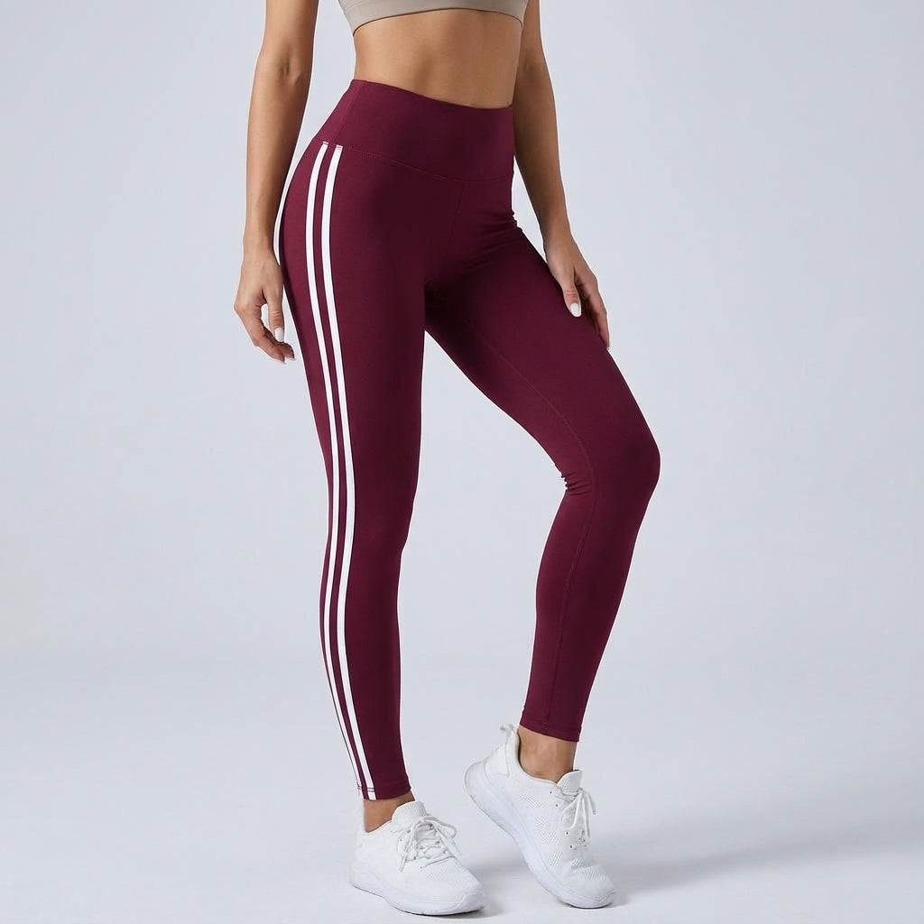 High-waisted burgundy workout leggings with three white side stripe lines.