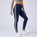 High-waisted dark blue workout leggings with three white side stripe lines.