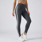 High-waisted dark gray workout leggings with three white side stripe lines.