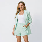 Mint green blazer and matching shorts set with open front and structured shorts.