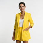 Yellow blazer and matching shorts set with open front and tailored, relaxed shorts.