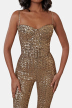 Gold sequin jumpsuit bodice with thin chain straps and belted waist