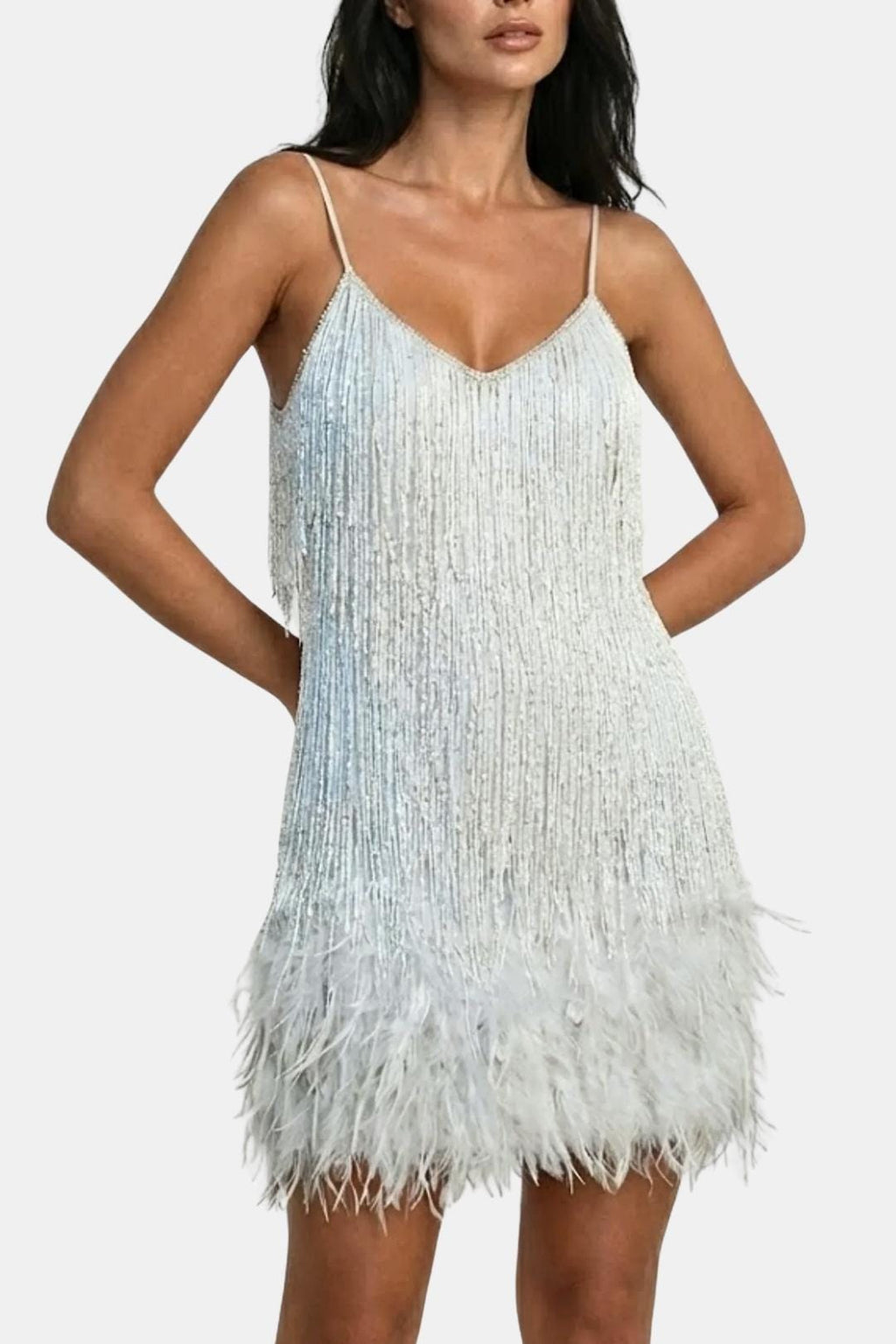 White sequin mini party dress with feather fringe hem and spaghetti straps.