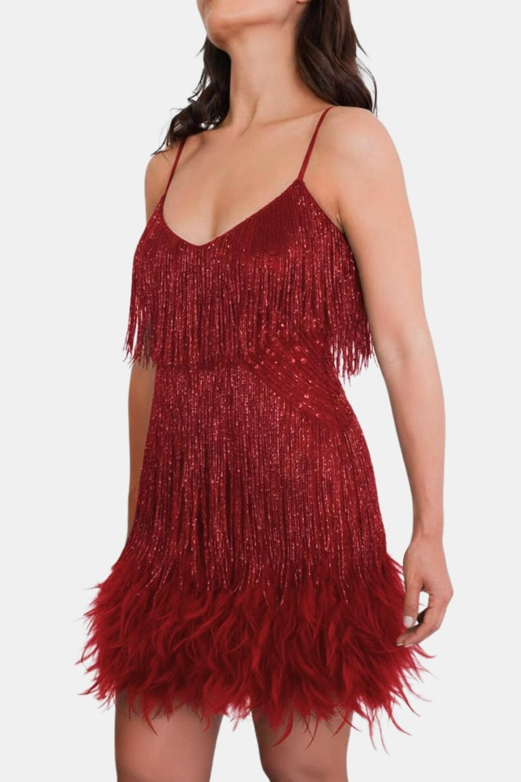 Red sequin mini party dress with feather fringe hem and thin spaghetti straps.