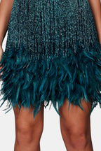 Teal-blue sequin mini dress with layered feather fringe hem detail.