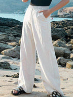 White high-waisted loose wide-leg pants with elastic waistband