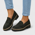 Black slip-on loafers with round toe and contrast sole trim