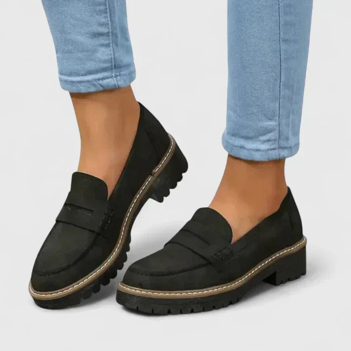 Black slip-on loafers with round toe and contrast sole trim