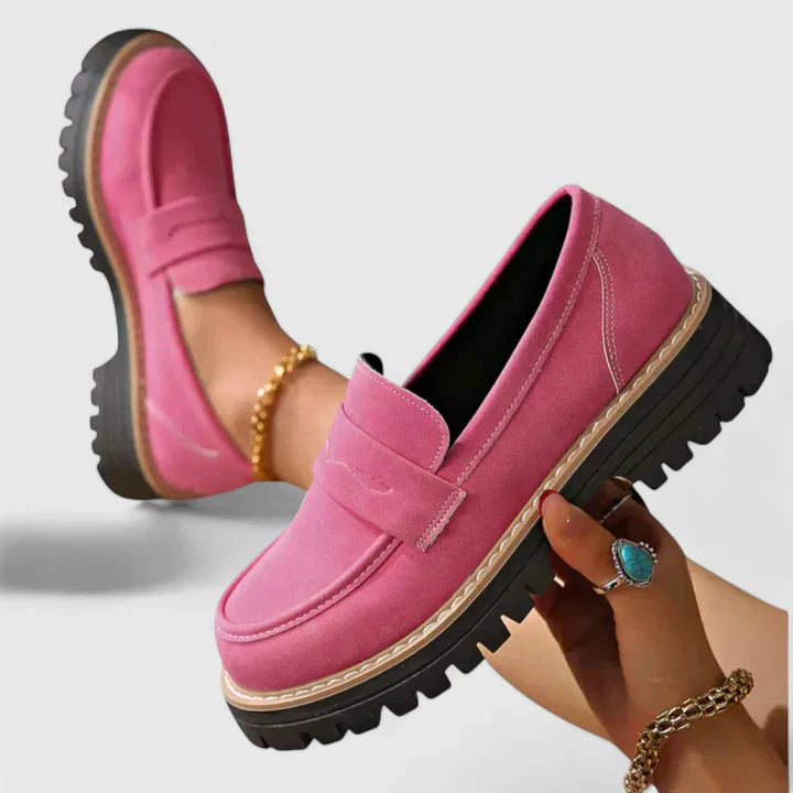 Pink slip-on loafers with round toe, suede look upper, and chunky tread sole