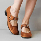 Brown Mary Jane shoes with adjustable buckle strap and side cutout