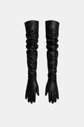 Pair of black long faux leather opera gloves with ruched tall cuffs and full fingers