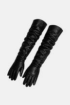 Pair of black long faux leather opera gloves with ruched cuffs and full fingers