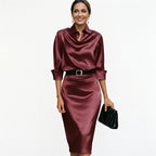 Burgundy satin cocktail midi dress with draped cowl neck, 3/4 sleeves and waist belt.