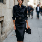 Black satin cocktail midi dress with draped cowl neck, 3/4 sleeves and waist belt.