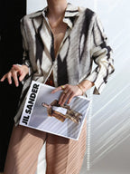 Women's abstract print button-down shirt, collared button front, long sleeves, vertical stripe-like pattern