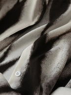 Abstract print button-down shirt fabric detail, button placket with white buttons