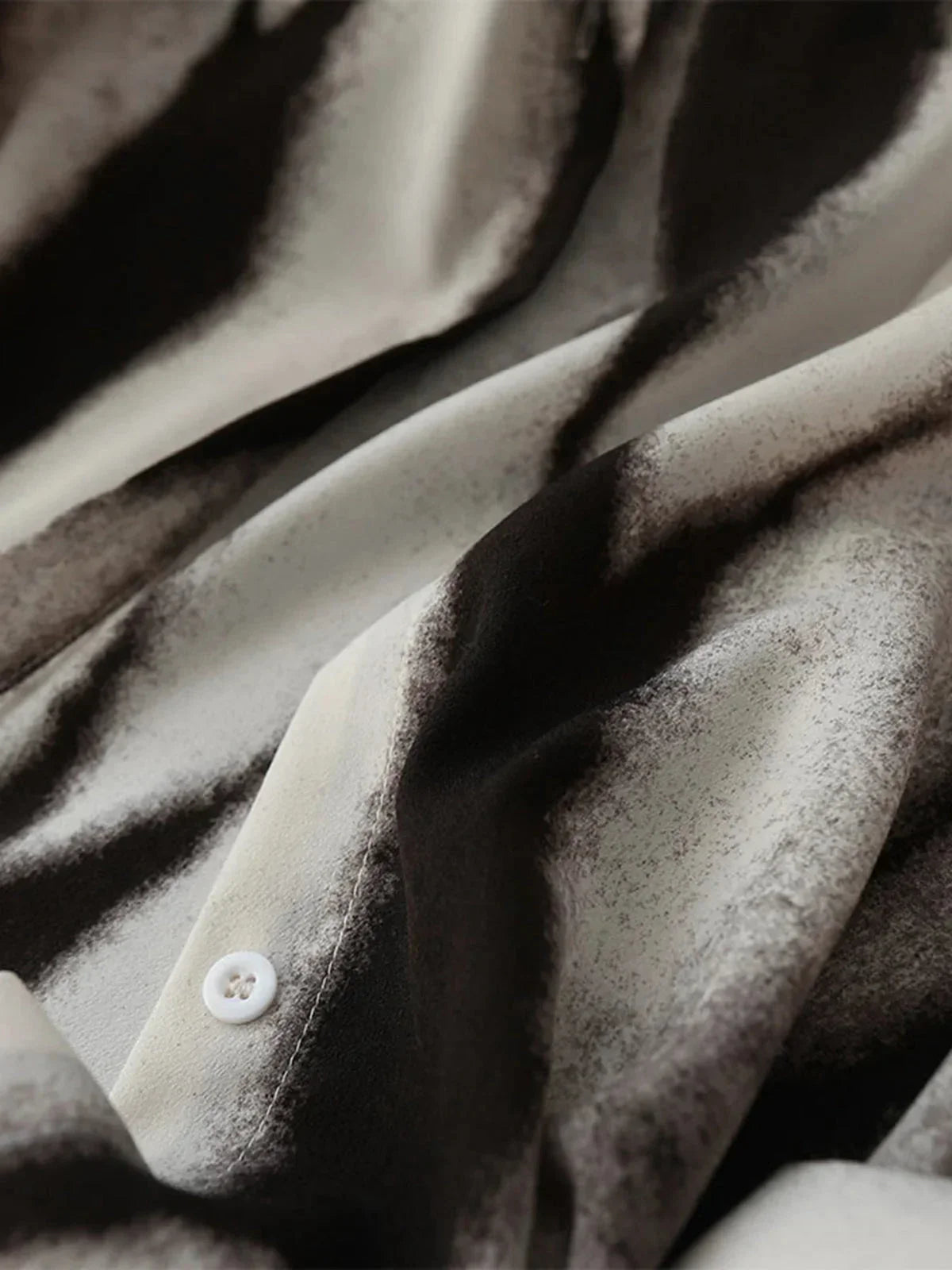 Abstract print button-down shirt fabric detail, button placket with white buttons