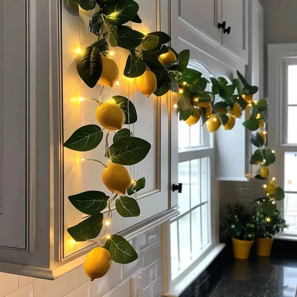 yellow fruit and green leaf fairy garland with warm string lights on window frame