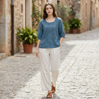 Blue embroidered blouse with 3/4 sleeves, gathered cuffs, and high-low hem