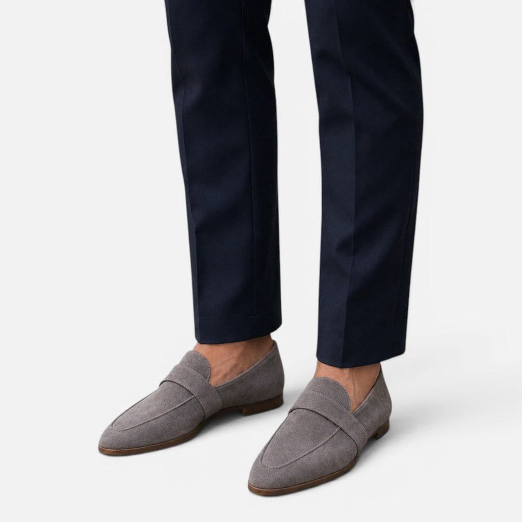 Women's suede pointed-toe loafers, gray slip-on with stitched saddle and low sole.