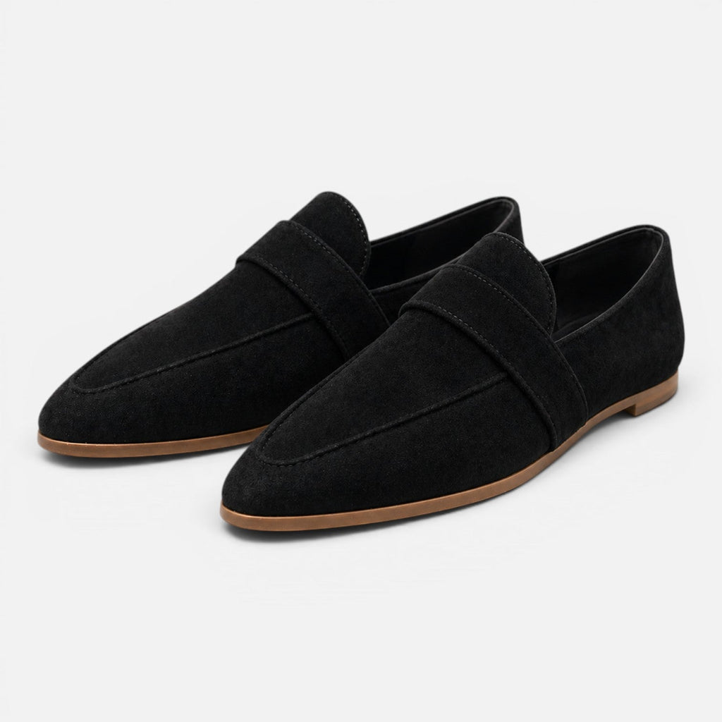 Women's black suede pointed-toe loafers, slip-on style with strap detail.
