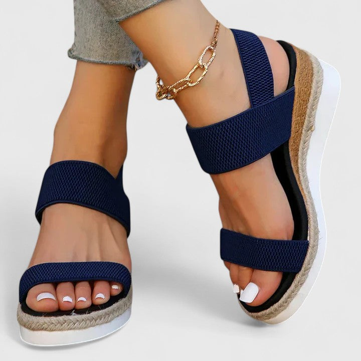 Navy two-strap platform sandals with open toe and jute-edged sole, ankle chain