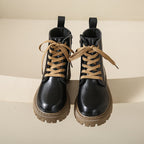 Women's black lace-up side-zip ankle boots with tan laces and chunky lug sole