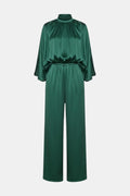 Green cape-sleeve jumpsuit with high neck and cinched waist, wide-leg pants.