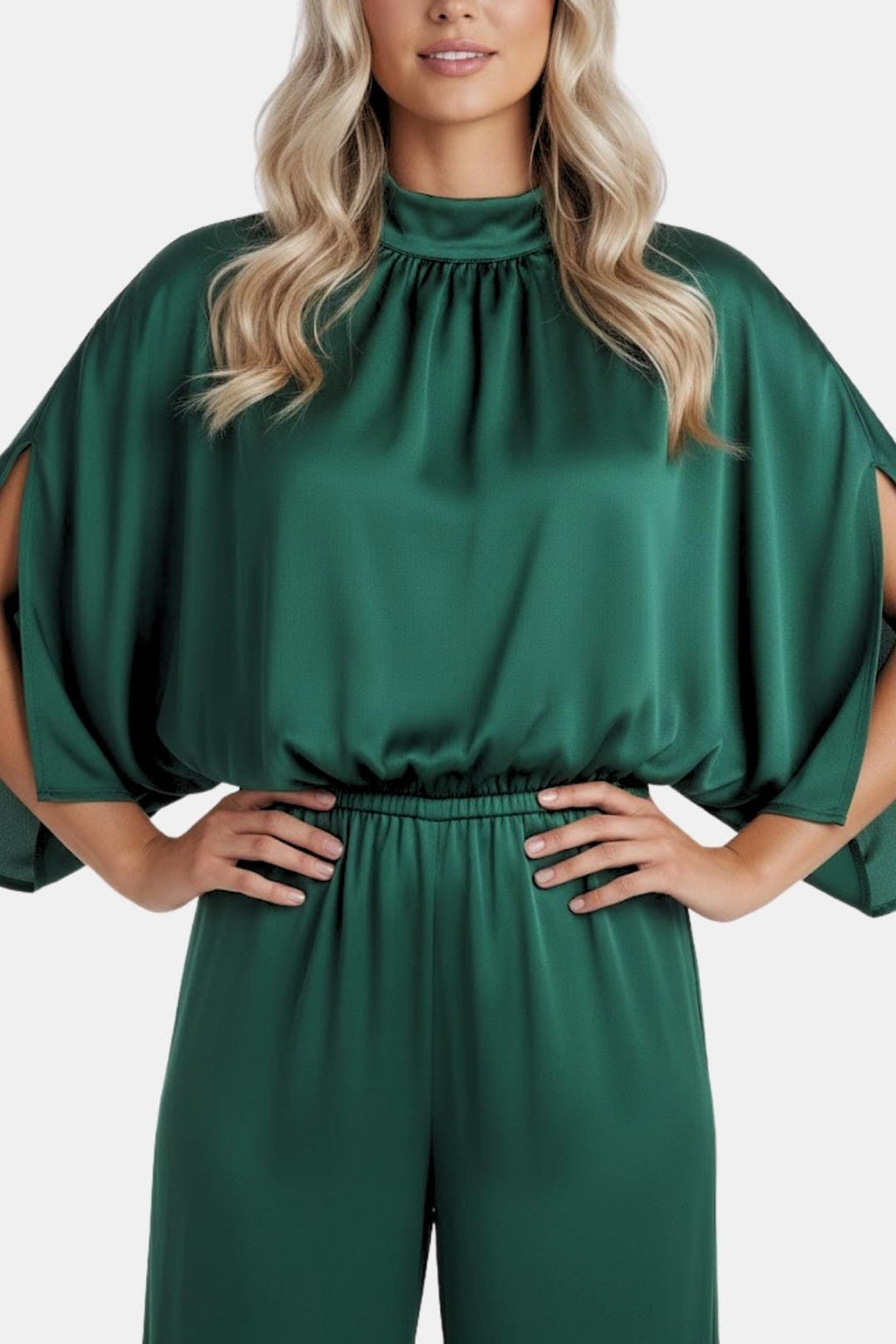 Green jumpsuit close-up: gathered high neckline and cinched waist at bodice.