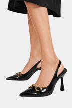 Black patent horsebit slingback pumps on heels with gold clasp and pointed toe