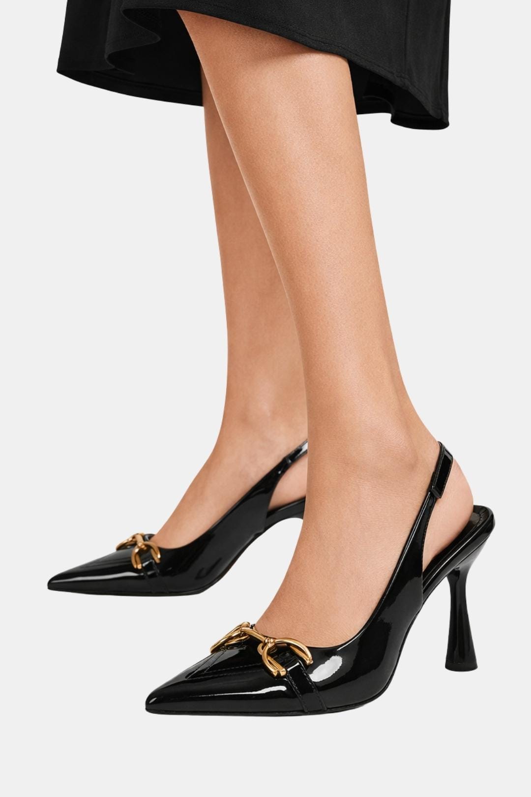Black patent horsebit slingback pumps on heels with gold clasp and pointed toe
