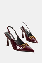 Burgundy patent horsebit slingback pumps with gold buckle detail and pointed toe