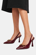 Burgundy patent horsebit slingback pumps with gold hardware and thin stiletto heel