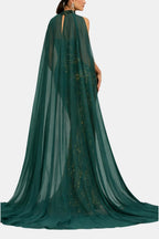 Back view of green sequin mermaid evening dress with long flowing cape