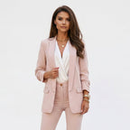 Women’s light pink blazer with notch lapel, front pockets, and tailored single-button fit