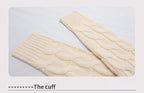 Light cream knitted cuff and sleeve edge with ribbed texture.