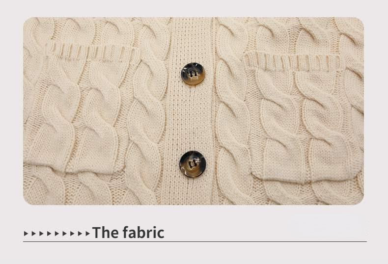Beige knitted fabric with cable knit texture and two button details.
