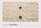 Beige knitted fabric with cable knit texture and two button details.