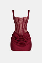 Burgundy lace corset mini dress with square neckline and draped overlay skirt
