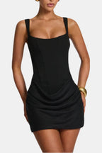 Black corset-style mini dress with square neckline and ruched cowl overlay skirt