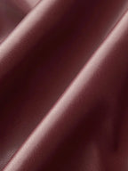 Burgundy faux leather mock-neck top fabric with subtle sheen and textured finish