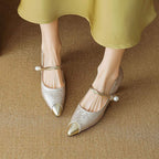 Metallic pointed kitten heels with pearl strap and gold buckle, low block heel