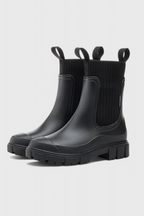 Black slip-on ankle boots with ribbed elastic sides and side gore pull-on panel.