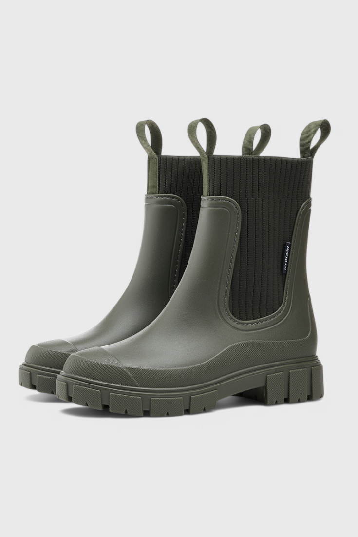 Green slip-on ankle boots with ribbed elastic shaft, side gore pull-on panel.
