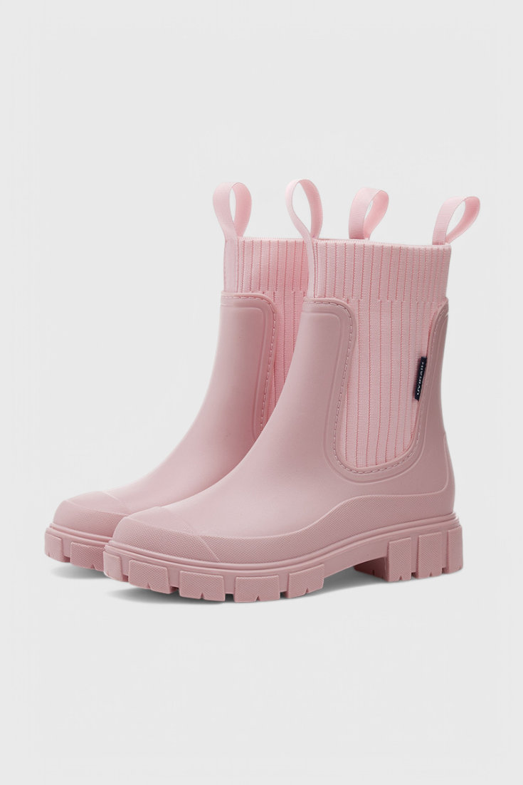 Pink slip-on ankle boots with ribbed elastic shaft and side gore pull-on panel.