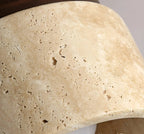 Close-up of textured travertine stone cylinder shade for flush mount ceiling lamp.