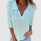 Light blue knit V-neck top with ribbed collar and cuffed three-quarter sleeves