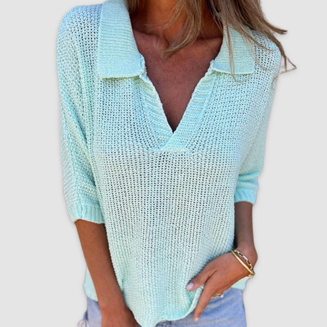 Light blue knit V-neck top with ribbed collar and cuffed three-quarter sleeves